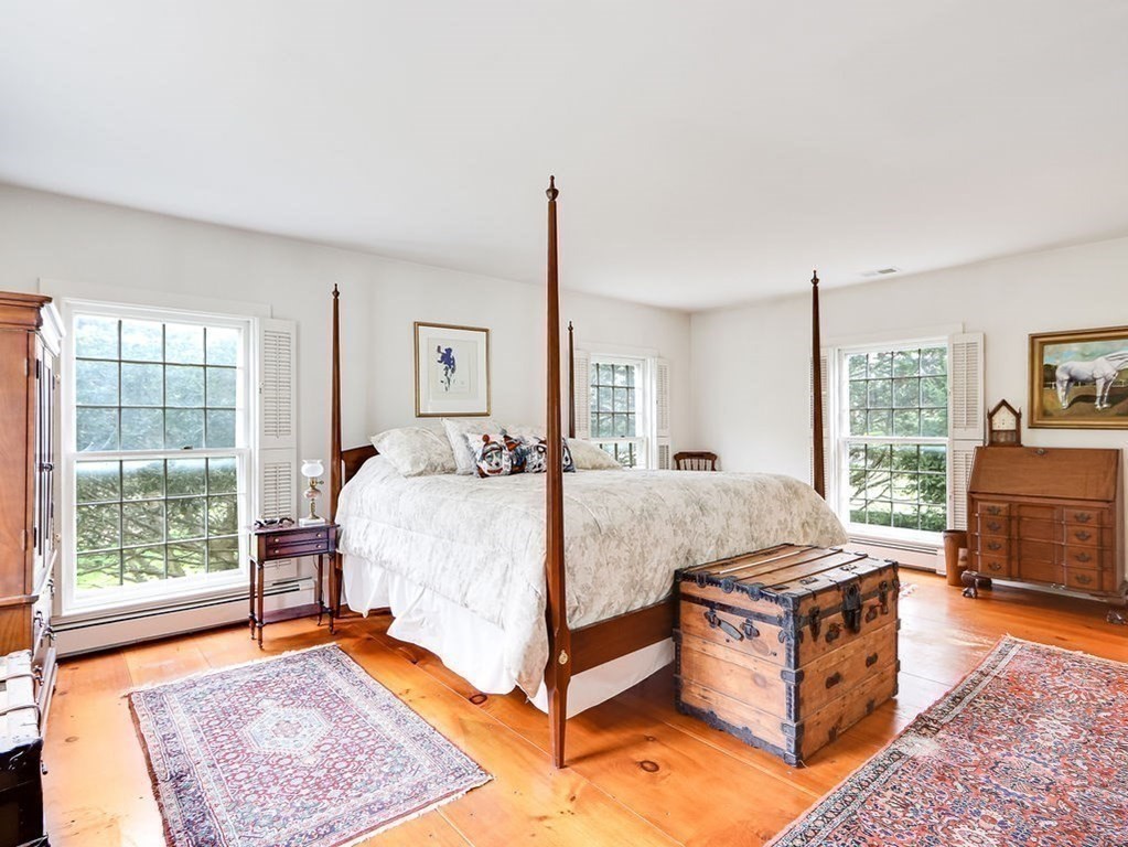 178 Dedham Street Dover, MA 02030 - Photo 17 of 42 a bed room with a bed and a chair