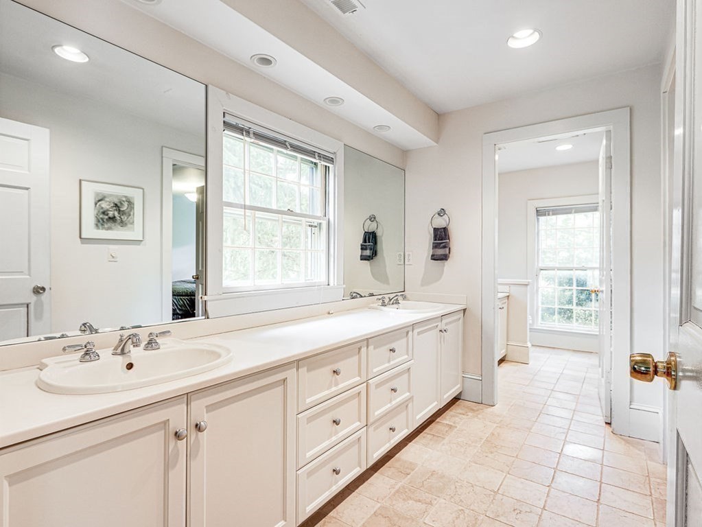 178 Dedham Street Dover, MA 02030 - Photo 20 of 42 a bathroom with a granite countertop double vanity sink a mirror and a bathtub