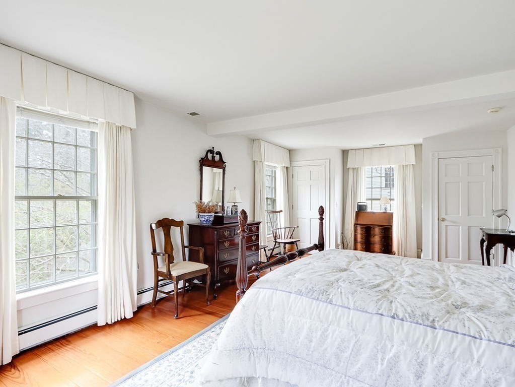 178 Dedham Street Dover, MA 02030 - Photo 25 of 42 a bed room with a bed and a chair