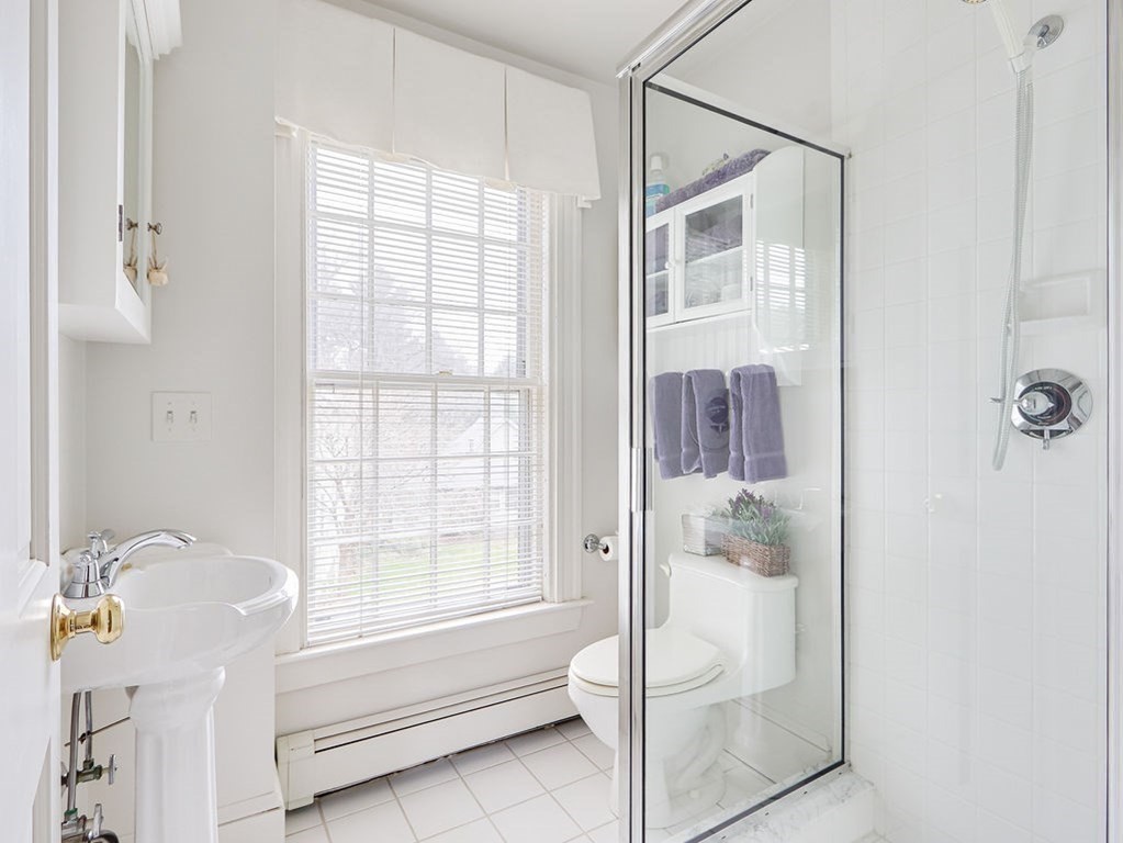 178 Dedham Street Dover, MA 02030 - Photo 26 of 42 a bathroom with a tub shower and window