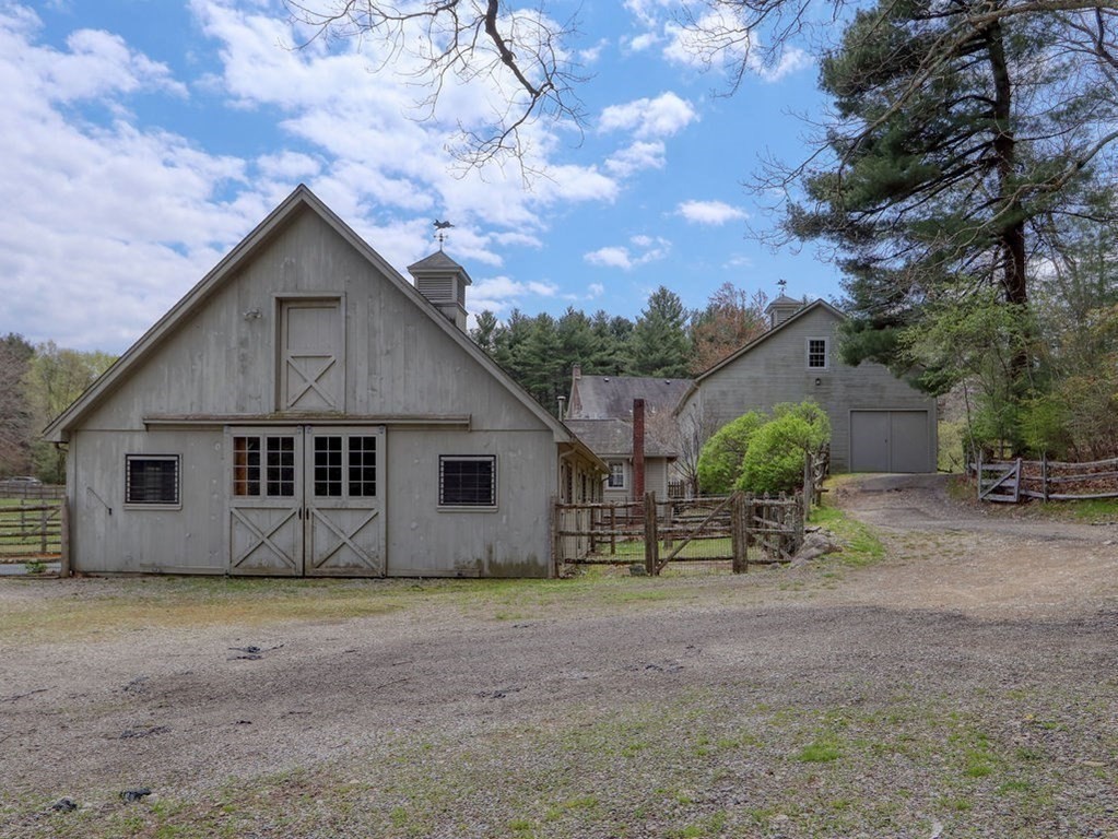 178 Dedham Street Dover, MA 02030 - Photo 32 of 42 a view of a house with large trees and wooden fence
