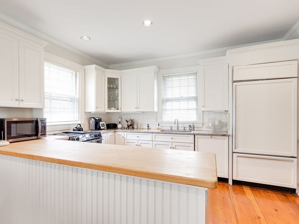 178 Dedham Street Dover, MA 02030 - Photo 8 of 42 a kitchen with stainless steel appliances granite countertop a refrigerator a sink dishwasher a stove with wooden cabinets and floor