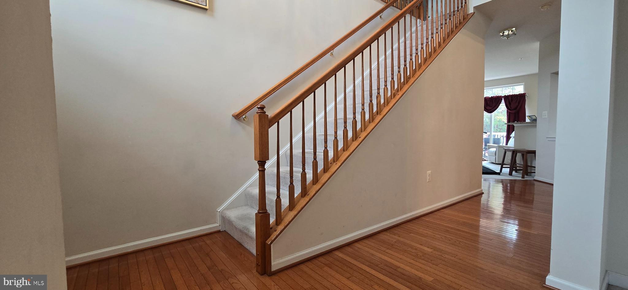 13005 Firestone Court Silver Spring, MD 20904 - Photo 18 of 47 a view of a hallway with wooden floor and staircase