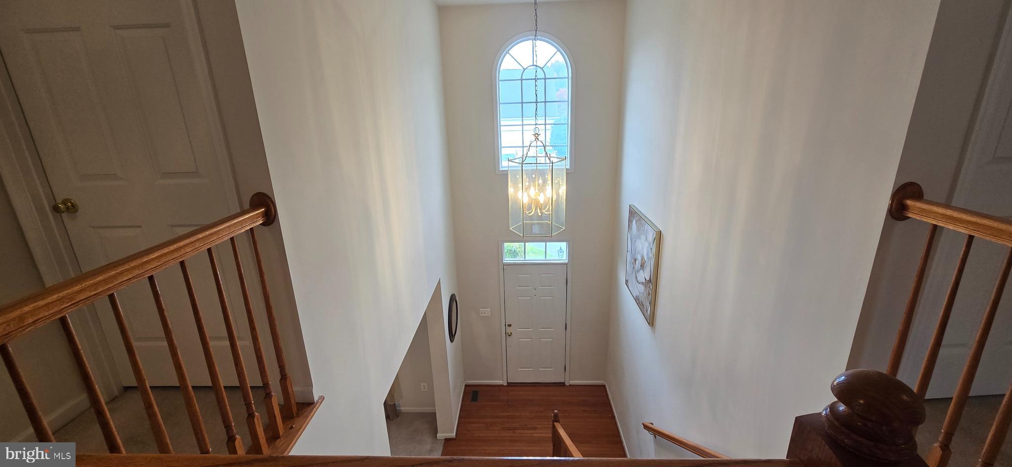 13005 Firestone Court Silver Spring, MD 20904 - Photo 23 of 47 a view of a hallway with wooden floor and stairs
