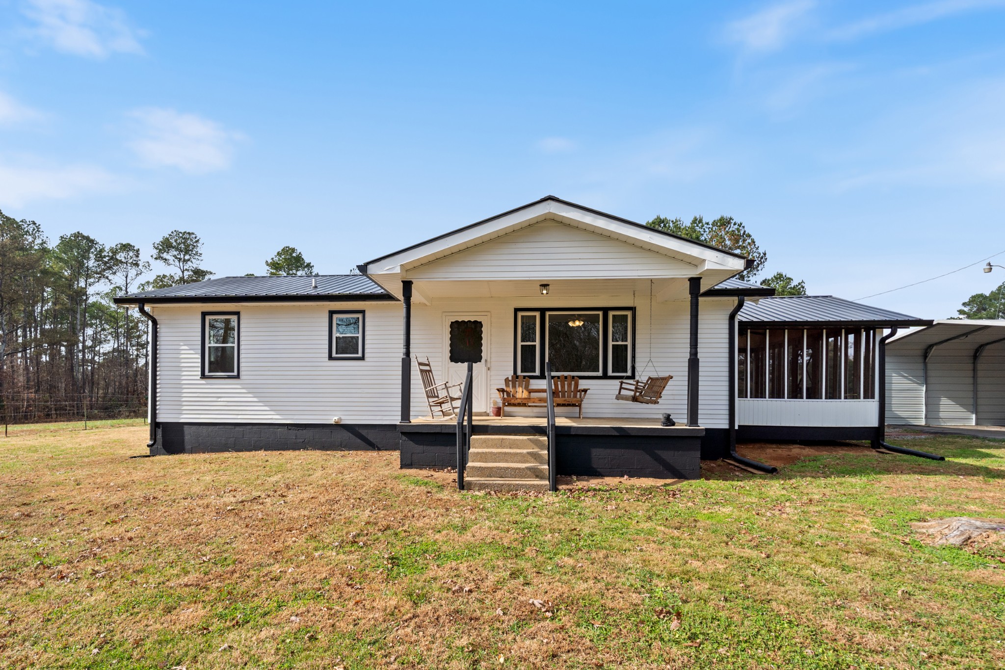 a view of a house with wooden deck and furniture