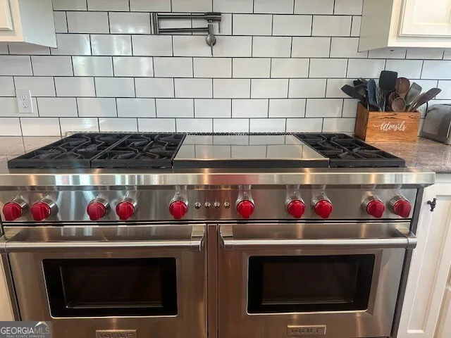 a utility room with wooden floor washer and dryer
