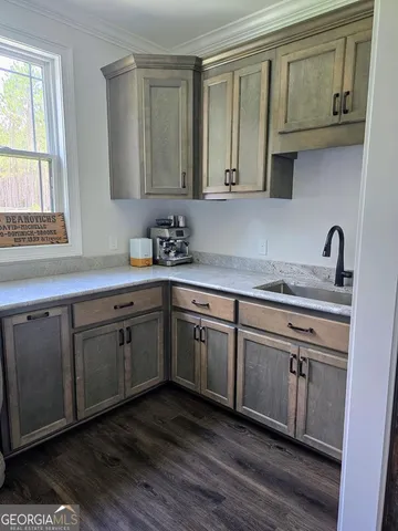 a bedroom with a bed and a flat tv screen on dresser
