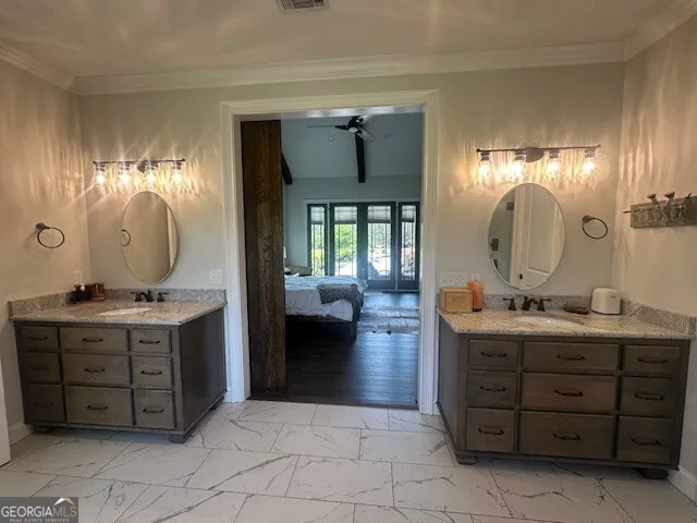 a kitchen with stainless steel appliances a sink a stove a refrigerator cabinets and a dining table