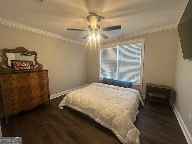 a room with a couch and a dresser with wooden floor