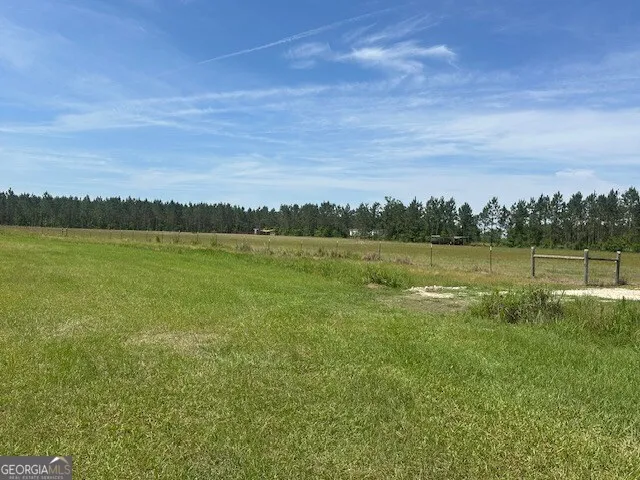 a kitchen with stainless steel appliances kitchen island granite countertop a table chairs and a chandelier