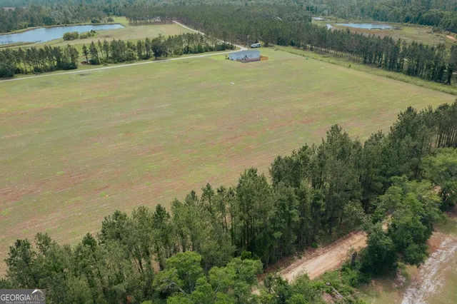 a kitchen that has a lot of white cabinets and a wooden floor