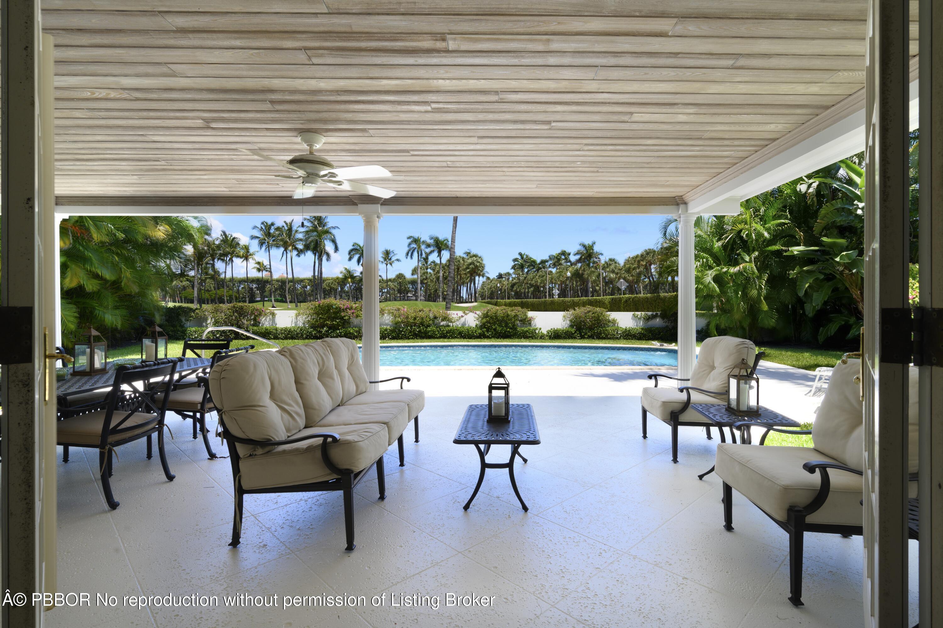 201 Pendleton Avenue Palm Beach, FL 33480 - Photo 17 of 22 a view of a patio with table and chairs potted plants with wooden floor and floor to ceiling window