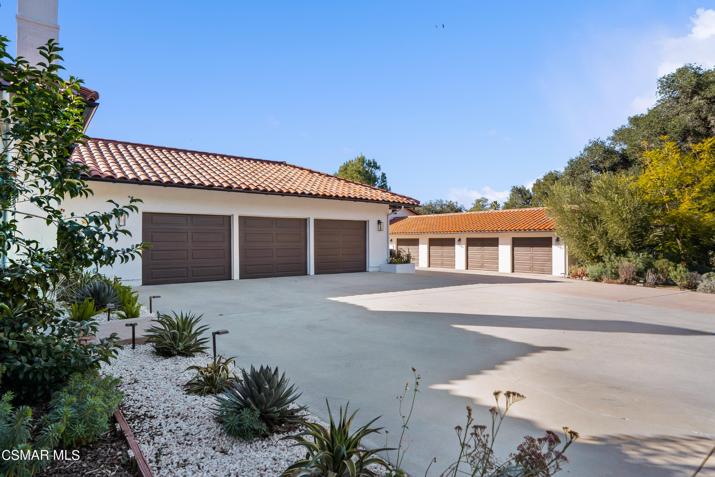 26205 Sand Canyon Road Canyon Country, CA 91387 - Photo 11 of 99 a front view of a house with a garden and outdoor seating