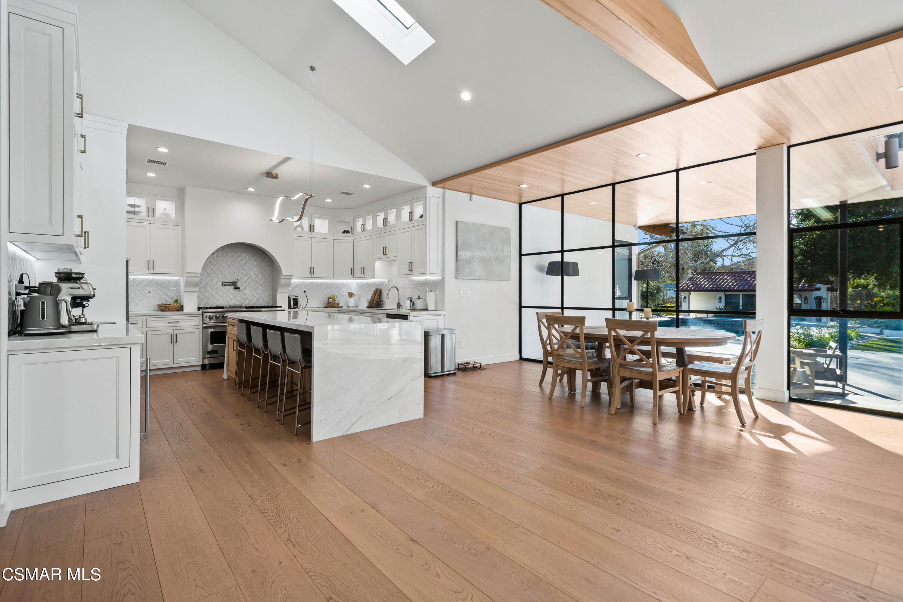 26205 Sand Canyon Road Canyon Country, CA 91387 - Photo 35 of 99 a kitchen with stainless steel appliances granite countertop a stove top oven a sink with dining table and chairs