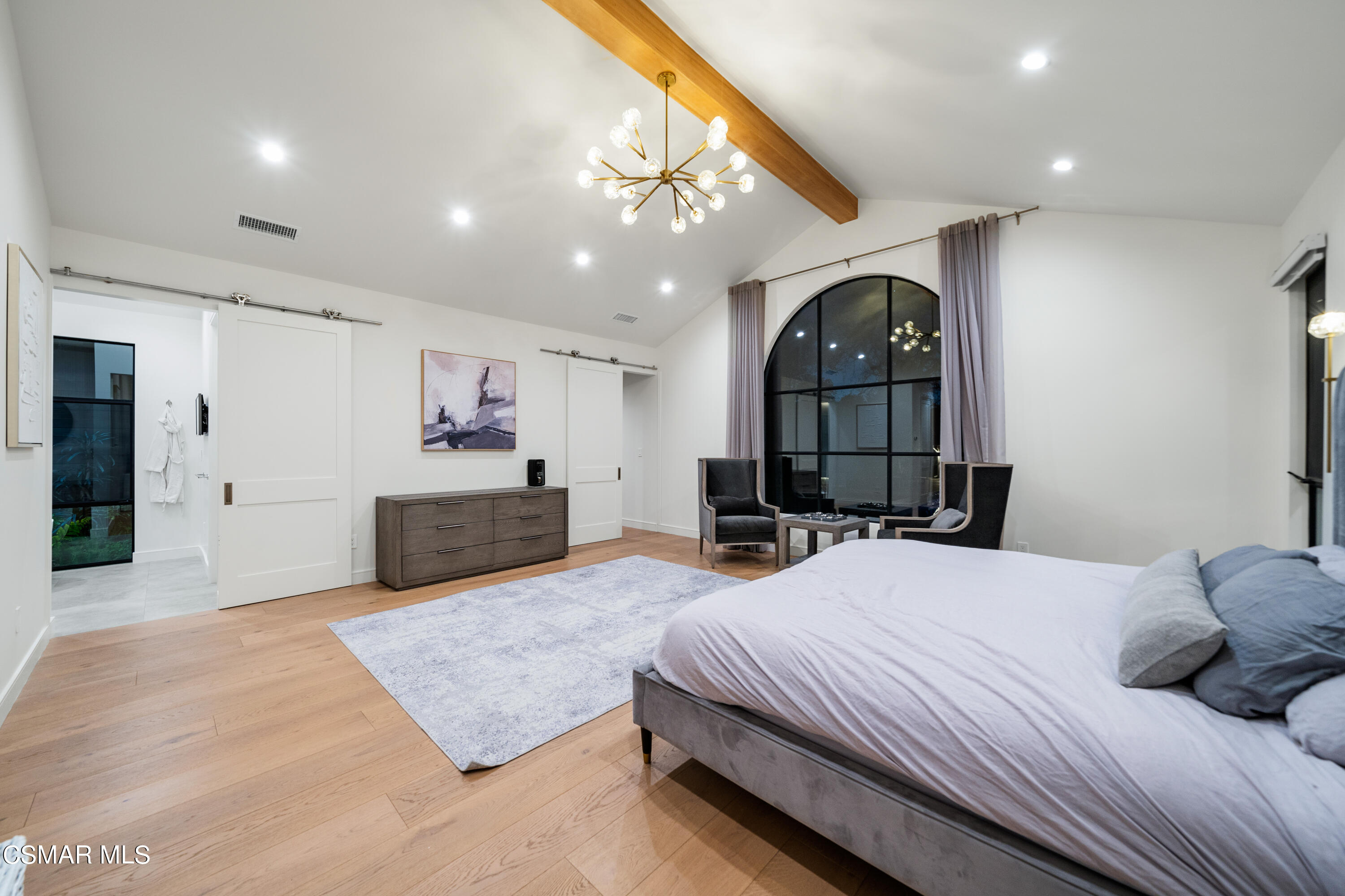 26205 Sand Canyon Road Canyon Country, CA 91387 - Photo 41 of 99 a spacious bedroom with a large bed a chandelier a mirror on dresser and a chandelier