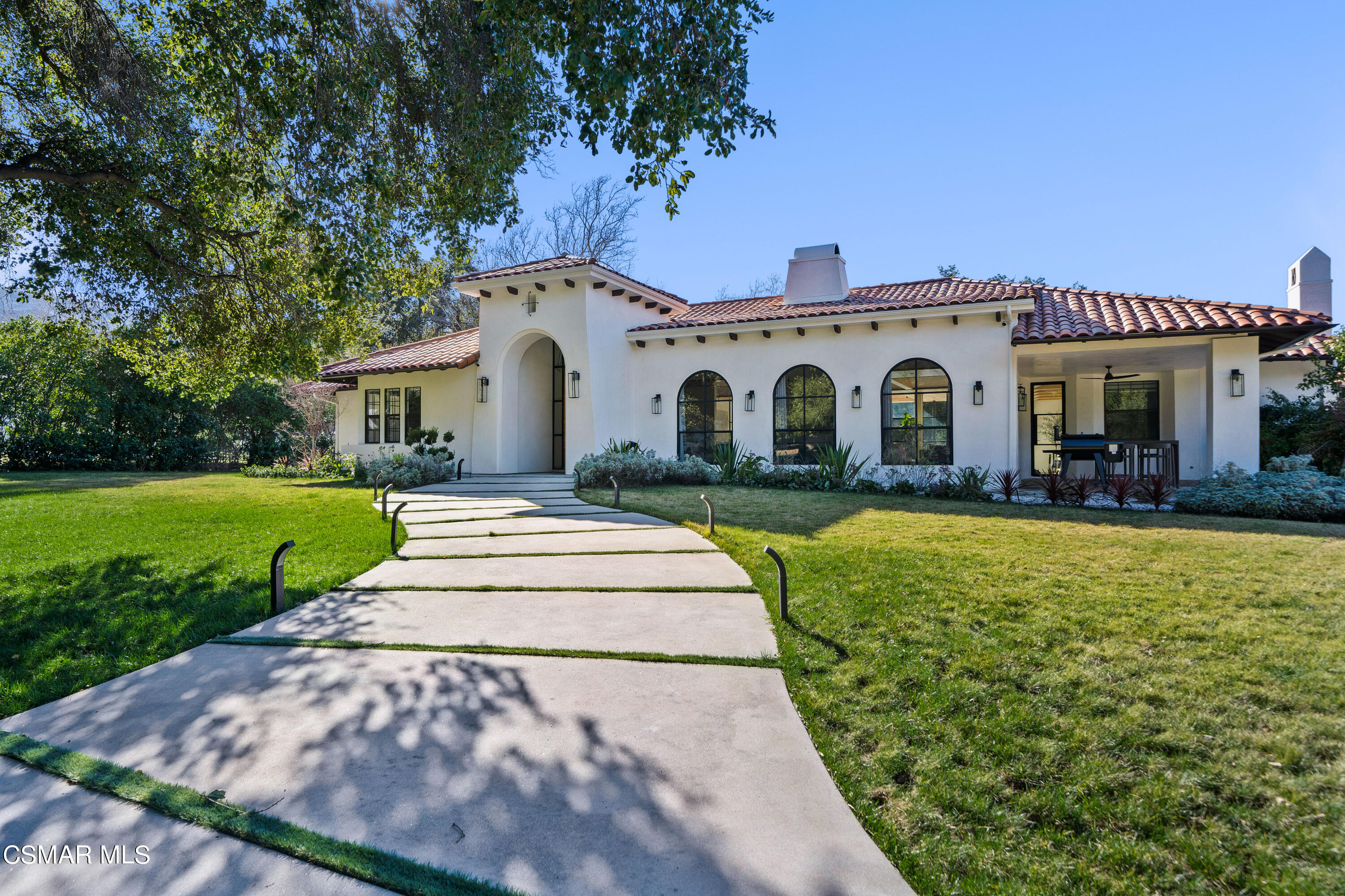 26205 Sand Canyon Road Canyon Country, CA 91387 - Photo 7 of 99 a front view of a house with a garden and yard