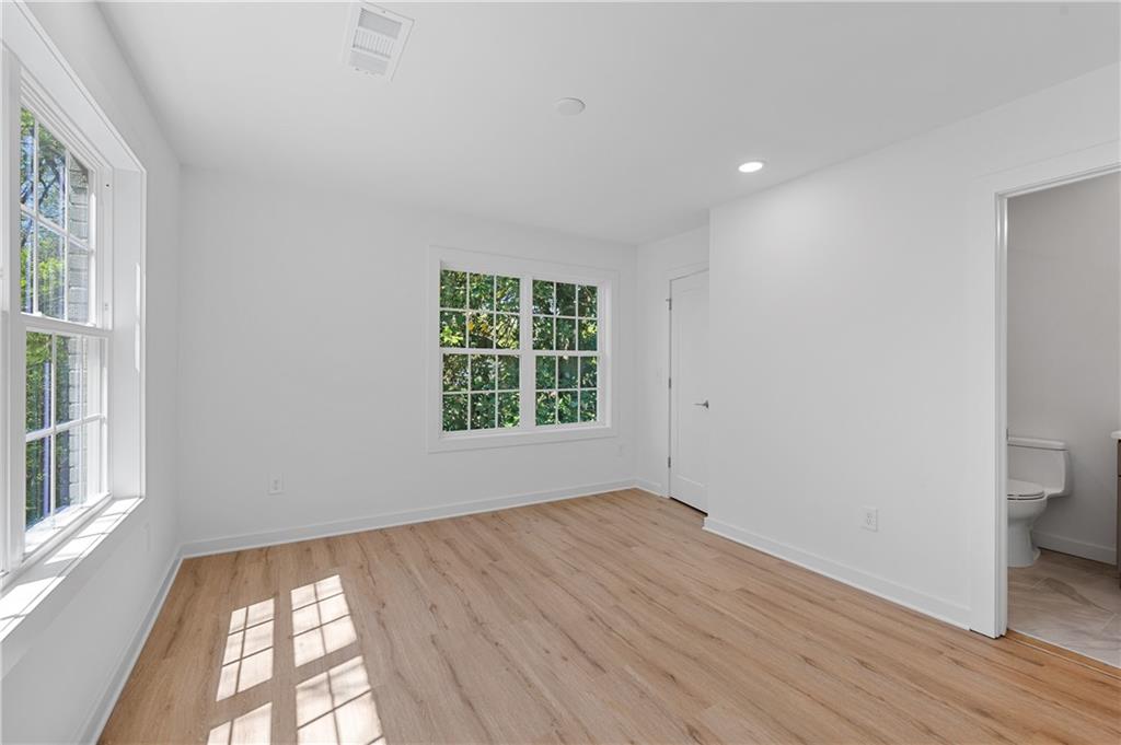 237 Howard Street Northeast, Unit 3 Atlanta, GA 30317 - Photo 11 of 18 wooden floor in an empty room with a window