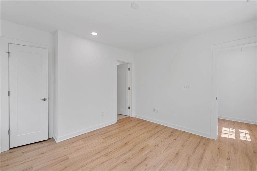 237 Howard Street Northeast, Unit 3 Atlanta, GA 30317 - Photo 12 of 18 a view of empty room with wooden floor and white doors