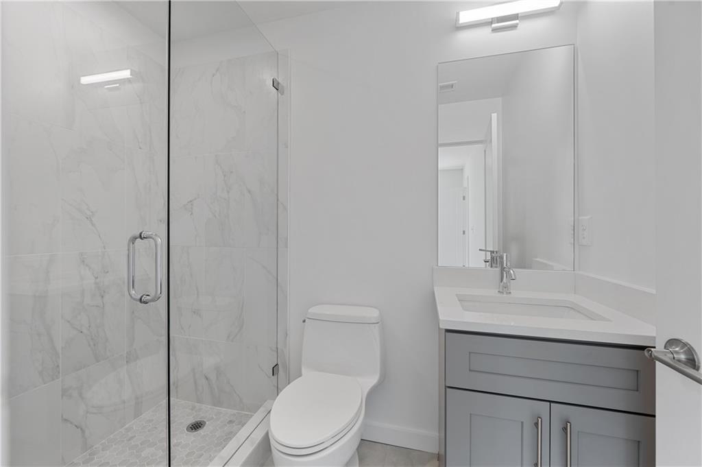 237 Howard Street Northeast, Unit 3 Atlanta, GA 30317 - Photo 13 of 18 a bathroom with a sink a toilet and shower