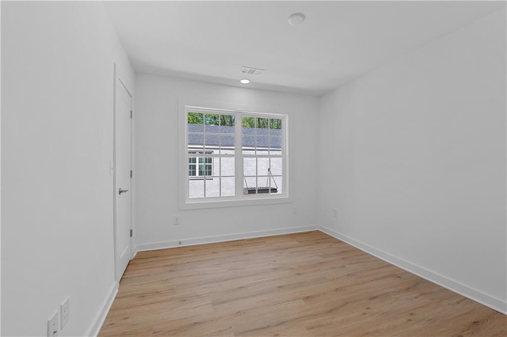 237 Howard Street Northeast, Unit 3 Atlanta, GA 30317 - Photo 14 of 18 an empty room with wooden floor and windows