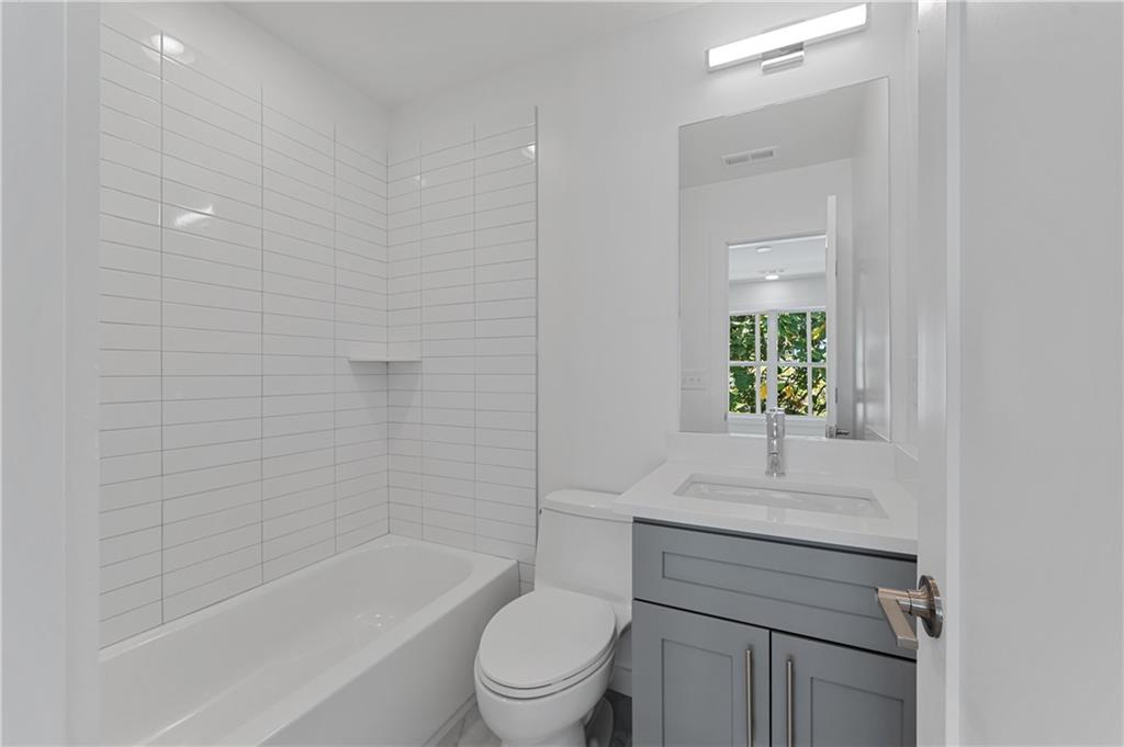 237 Howard Street Northeast, Unit 3 Atlanta, GA 30317 - Photo 16 of 18 a bathroom with a sink toilet and bathtub