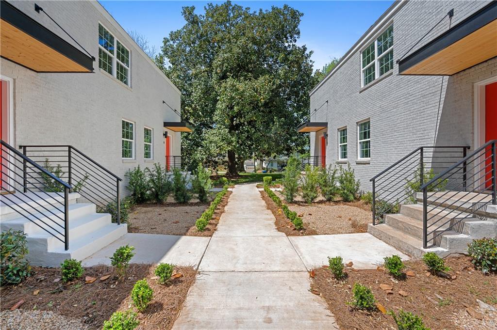 237 Howard Street Northeast, Unit 3 Atlanta, GA 30317 - Photo 18 of 18 a view of a pathway with house and garden