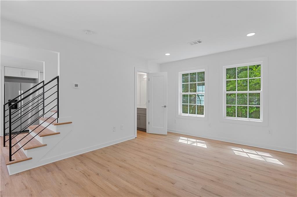 237 Howard Street Northeast, Unit 3 Atlanta, GA 30317 - Photo 3 of 18 a view of an empty room with wooden floor and a window