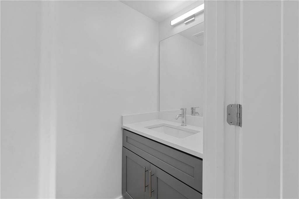 237 Howard Street Northeast, Unit 3 Atlanta, GA 30317 - Photo 4 of 18 a bathroom with a sink and a mirror