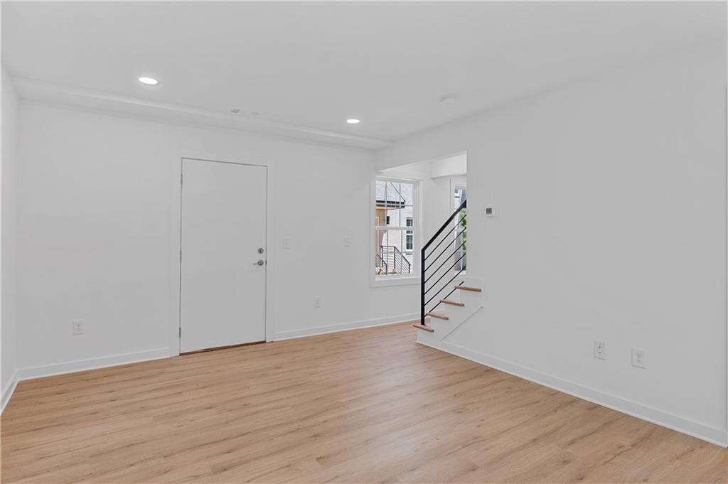 237 Howard Street Northeast, Unit 3 Atlanta, GA 30317 - Photo 5 of 18 a view of an empty room with wooden floor and entryway