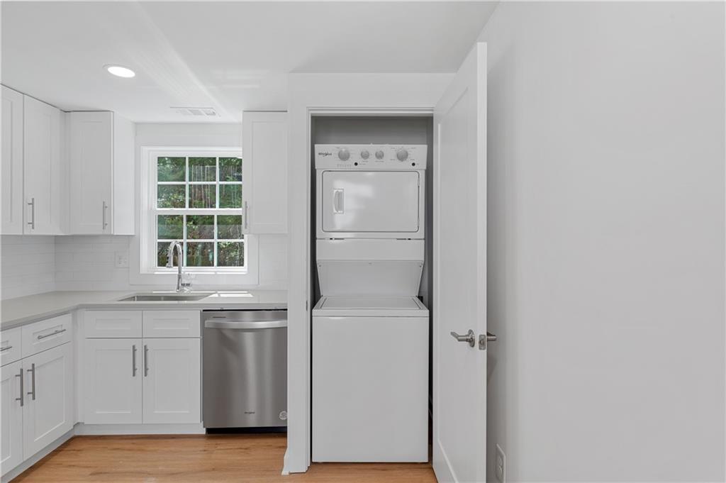 237 Howard Street Northeast, Unit 3 Atlanta, GA 30317 - Photo 9 of 18 a view of a kitchen with white cabinets and a refrigerator