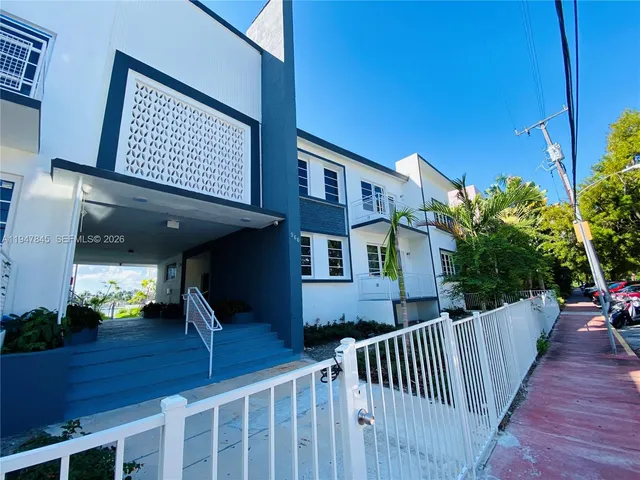 a view of a house with wooden fence