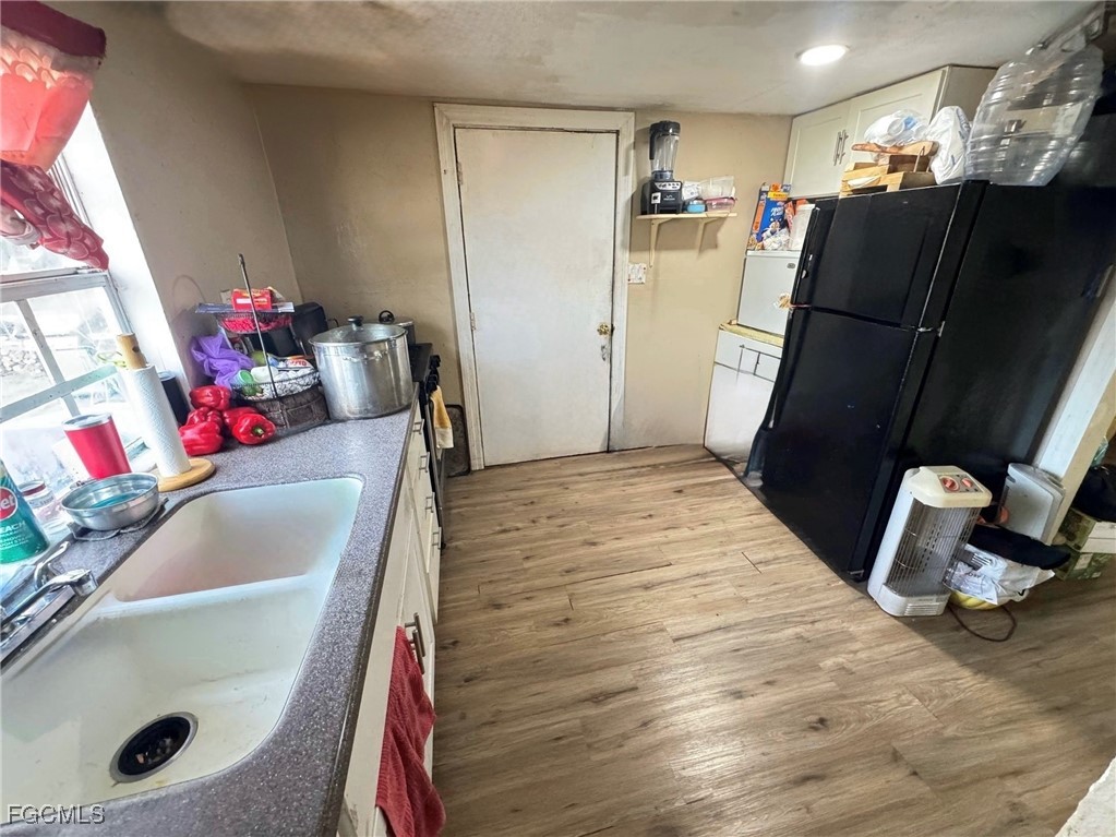 306 13th Street Southeast Immokalee, FL 34142 - Photo 4 of 11 a bathroom with a sink and a mirror