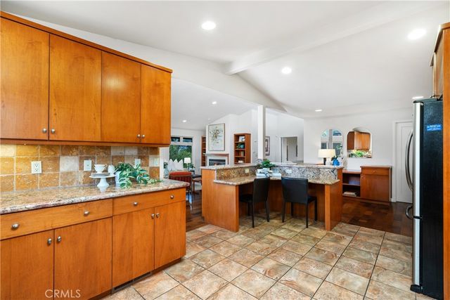 a kitchen with a sink dining table and chairs