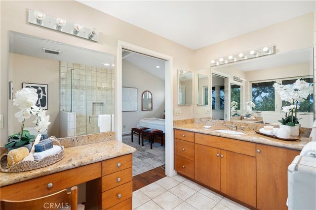 a spacious bathroom with a granite countertop sink mirror and shower