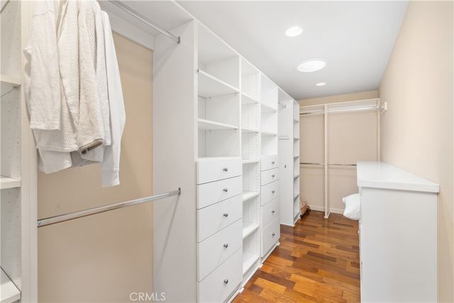 a view of walk in closet with empty racks