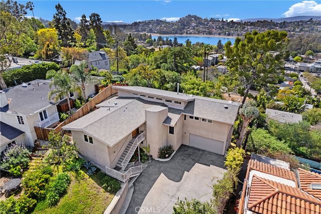 an aerial view of a house with a yard