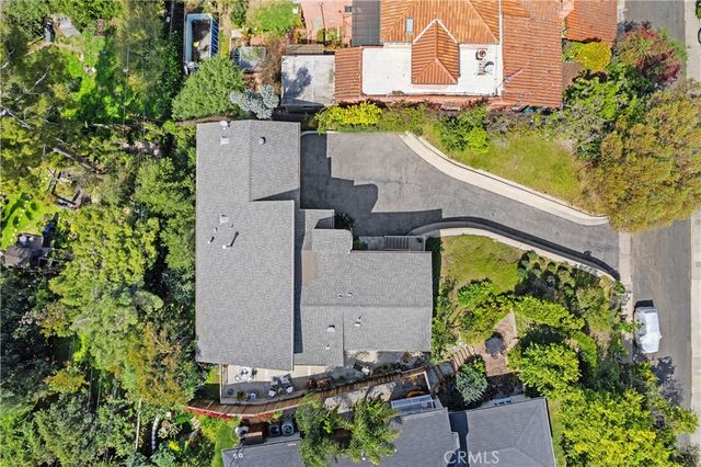 an aerial view of a house with a garden and plants
