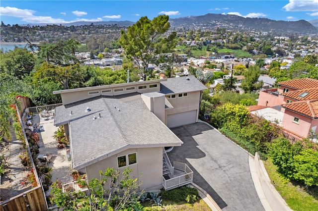an aerial view of multiple houses with a yard
