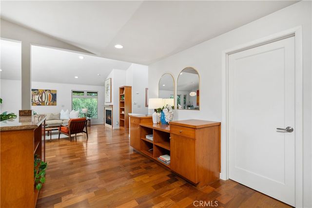 a large living room with stainless steel appliances granite countertop a couch and a view of living room