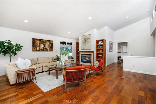 a living room with fireplace furniture and a wooden floor
