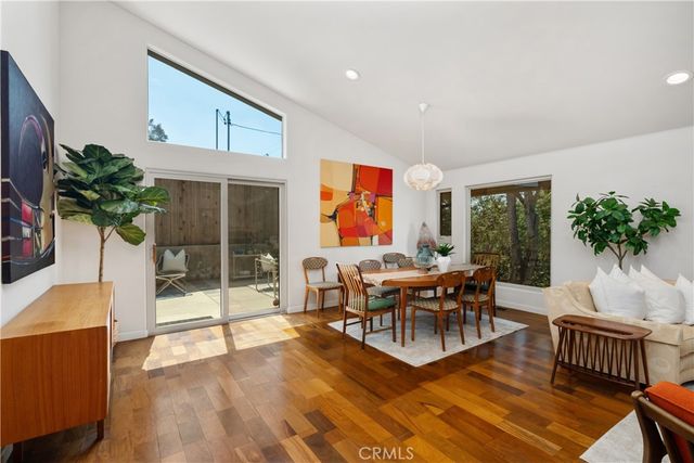 a living room with furniture potted plant and a large window