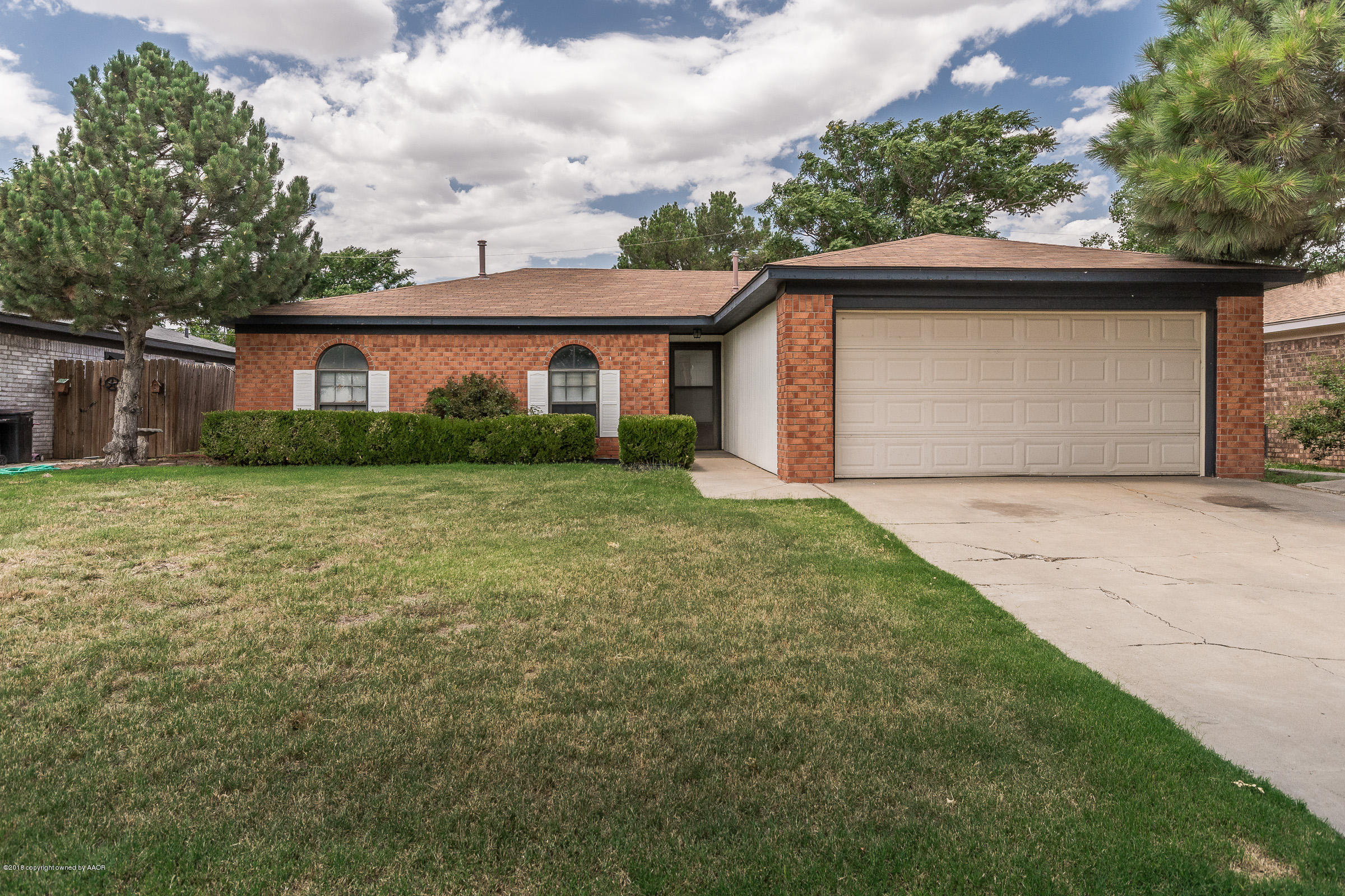 5340 Whitney Lane Amarillo, TX 79110 - Photo 2 of 14 a view of a house with a yard and garage