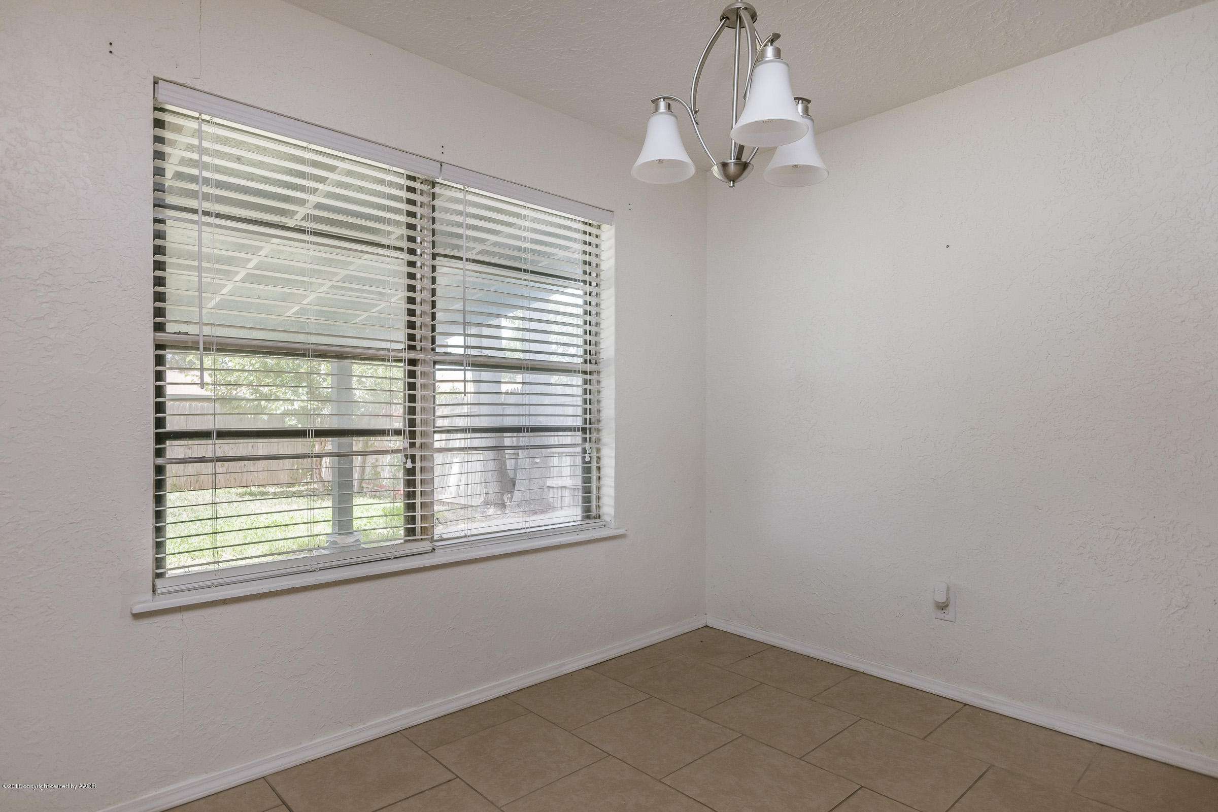 5340 Whitney Lane Amarillo, TX 79110 - Photo 5 of 14 a view of a room with a window and a ceiling fan