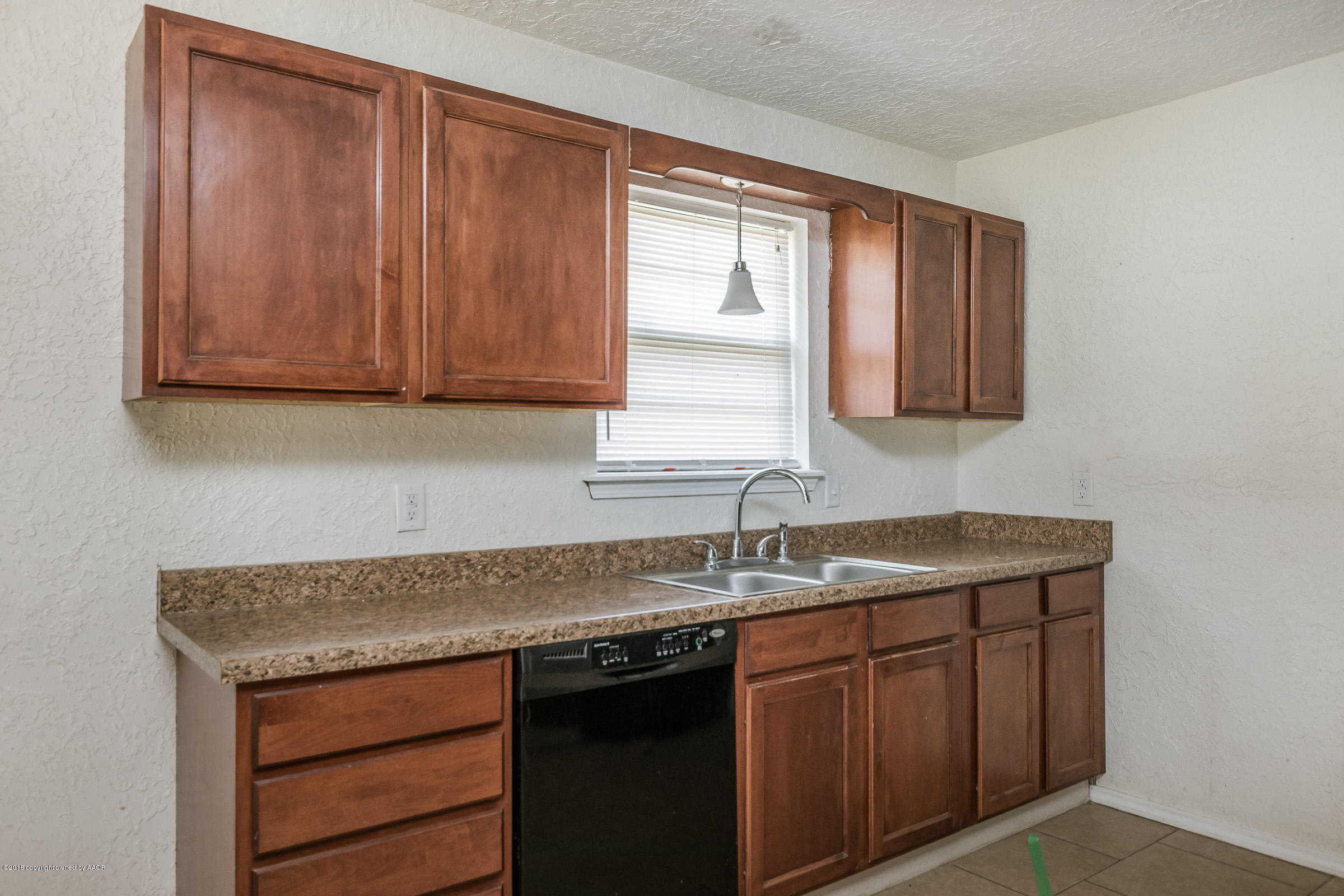5340 Whitney Lane Amarillo, TX 79110 - Photo 6 of 14 a kitchen with a sink cabinets and a window