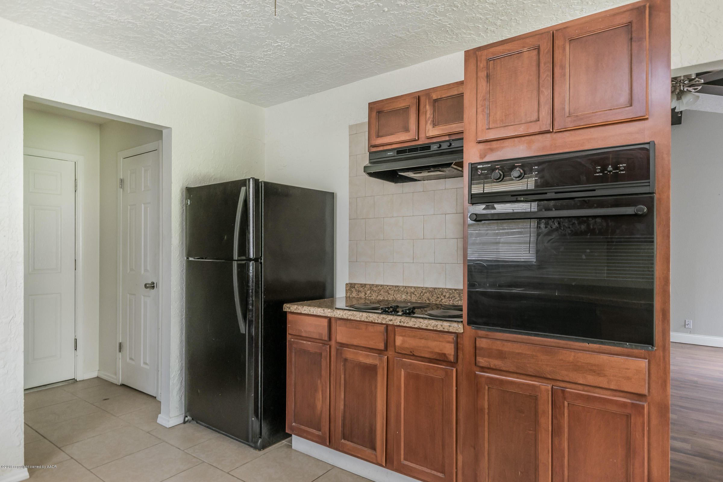 5340 Whitney Lane Amarillo, TX 79110 - Photo 7 of 14 a kitchen with stainless steel appliances granite countertop a refrigerator stove and cabinets