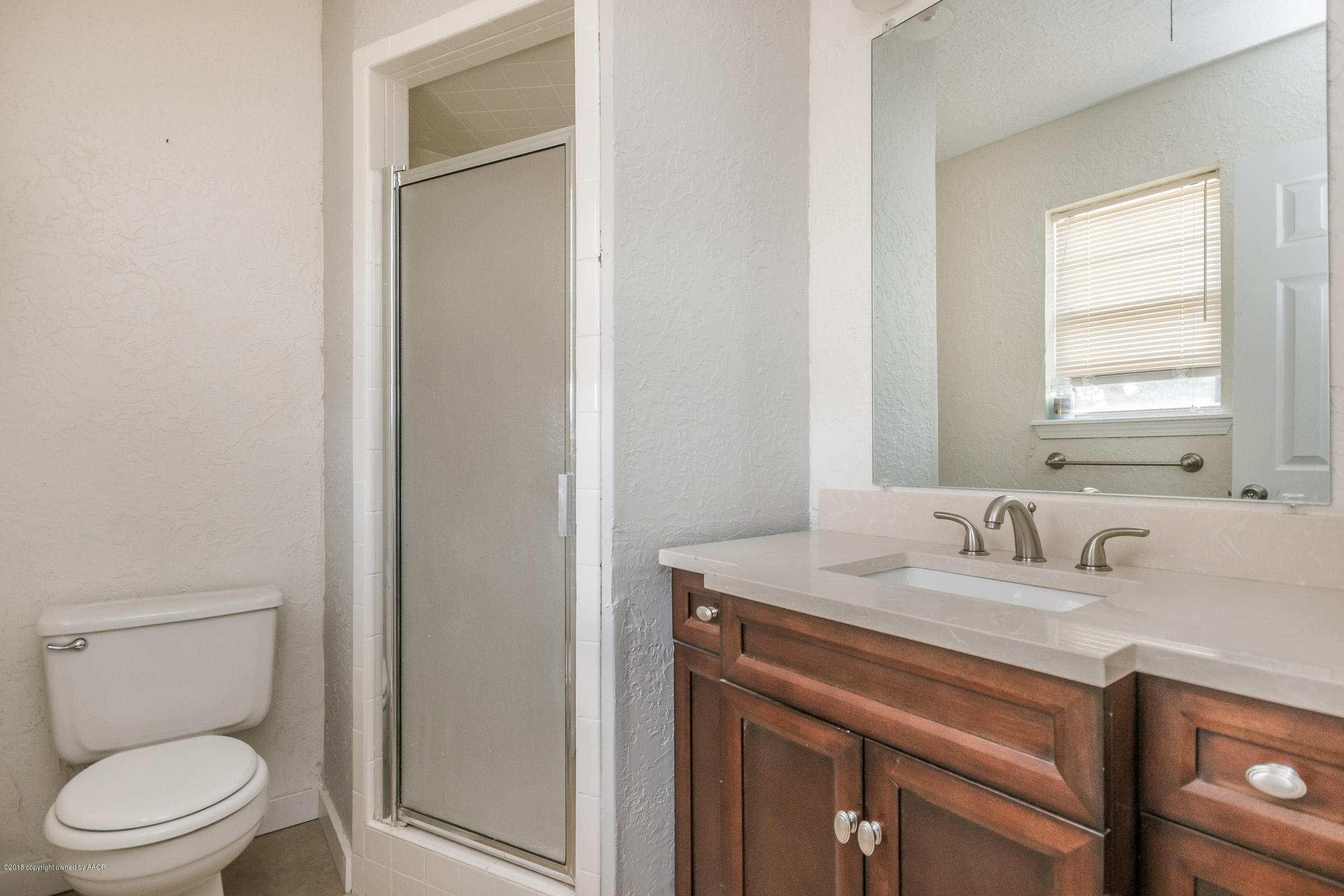 5340 Whitney Lane Amarillo, TX 79110 - Photo 9 of 14 a bathroom with a toilet sink and mirror