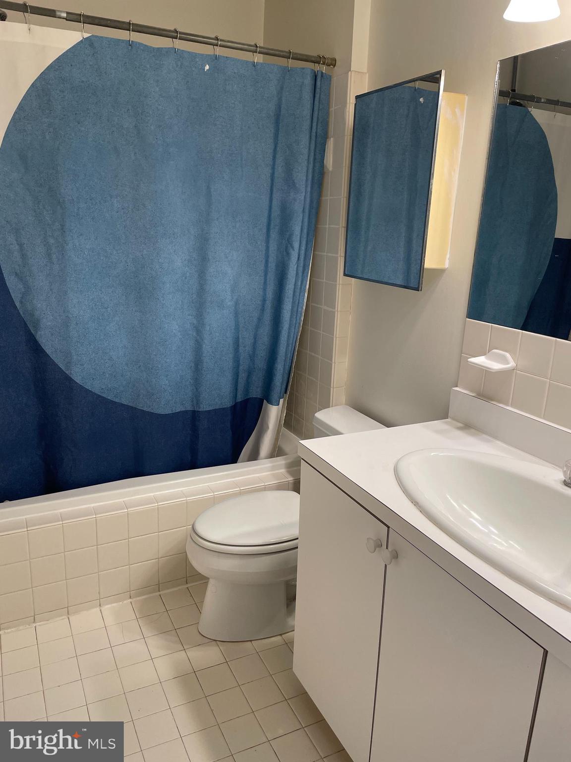 1856 Kalorama Road Northwest, Unit 4 Washington, DC 20009 - Photo 6 of 6 a white toilet sitting next to a bathroom sink and vanity