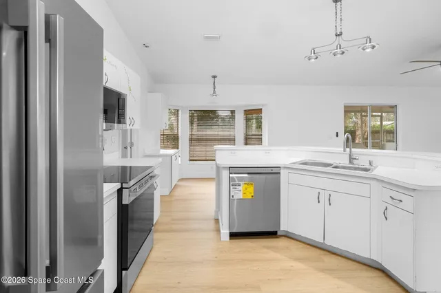 a spacious bathroom with a granite countertop sink and a bathtub