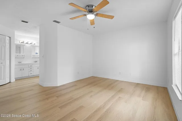 wooden floor in an empty room with a window
