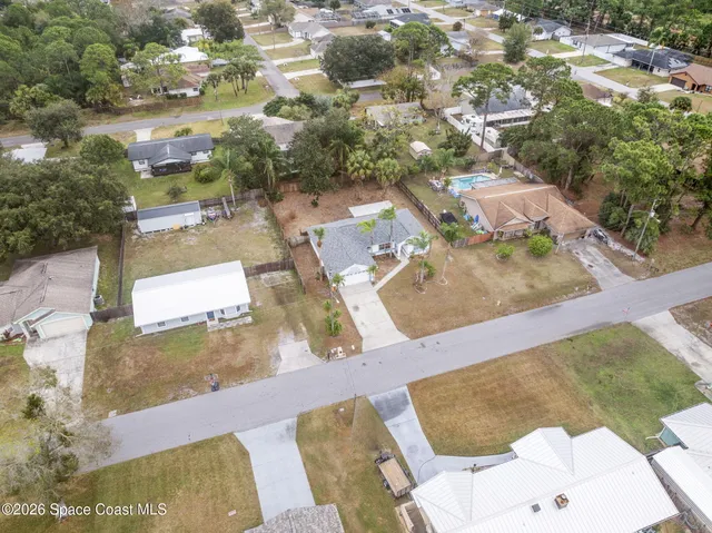 an aerial view of residential houses with outdoor space